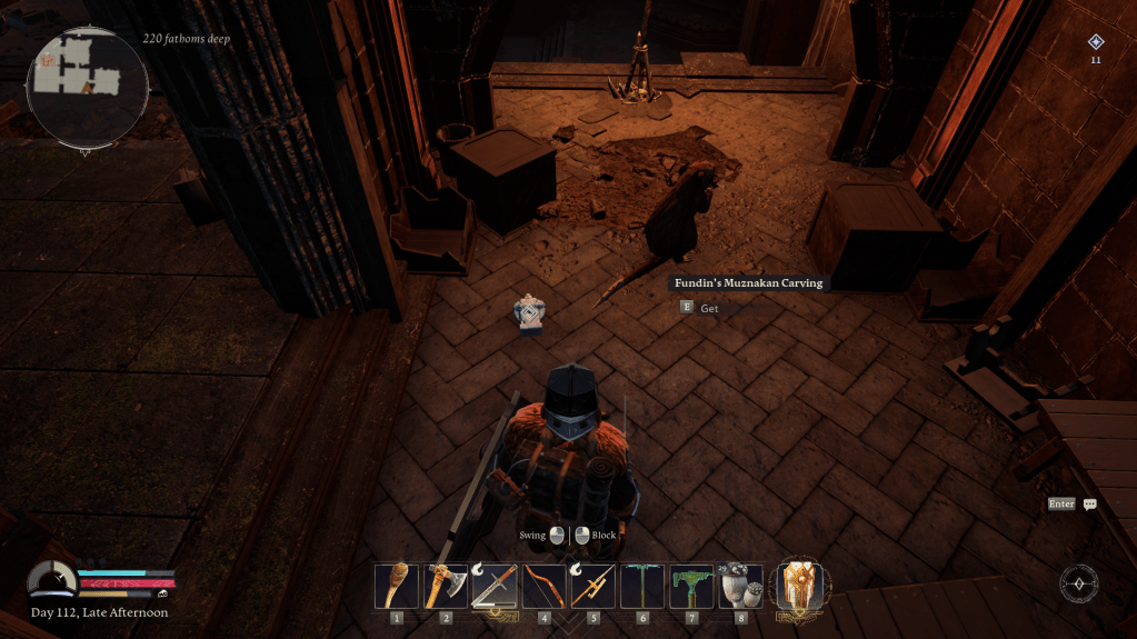 A carving of a dwarf on a stone floor in return to moria